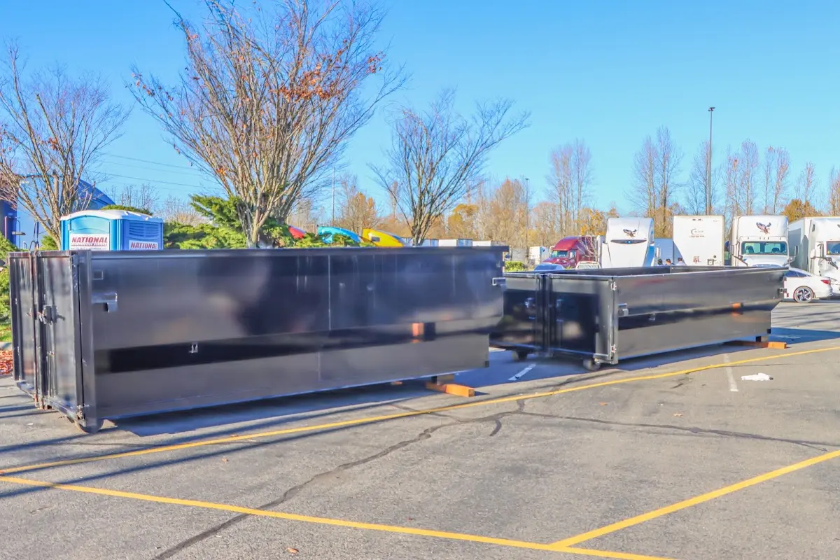 Professional dumpster rental service with roll-off container on residential driveway in Florissant